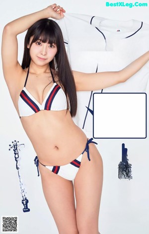 A woman in a blue and white bikini holding a stuffed animal.