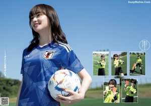 A woman holding a soccer ball on top of a field.