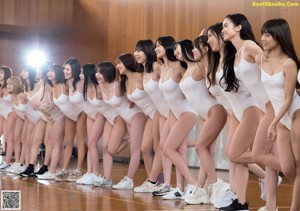 A group of women in white bathing suits posing for a picture.
