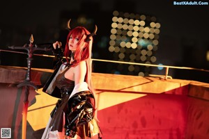 A woman with red hair and horns sitting on a chair.