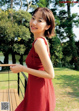 A woman in a blue tank top on a magazine cover.
