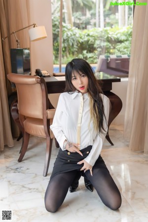 A woman sitting on a chair in a room.