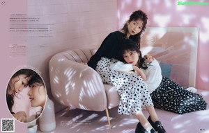 A woman laying on top of a pink stool.