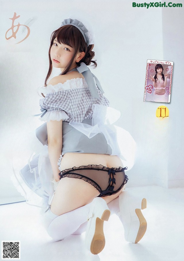 A woman in a maid outfit is posing for a magazine.