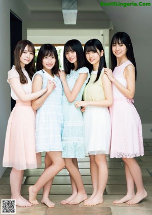 A group of young women in school uniforms posing for a magazine.