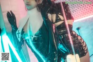 A couple of women dressed in latex posing for a picture.